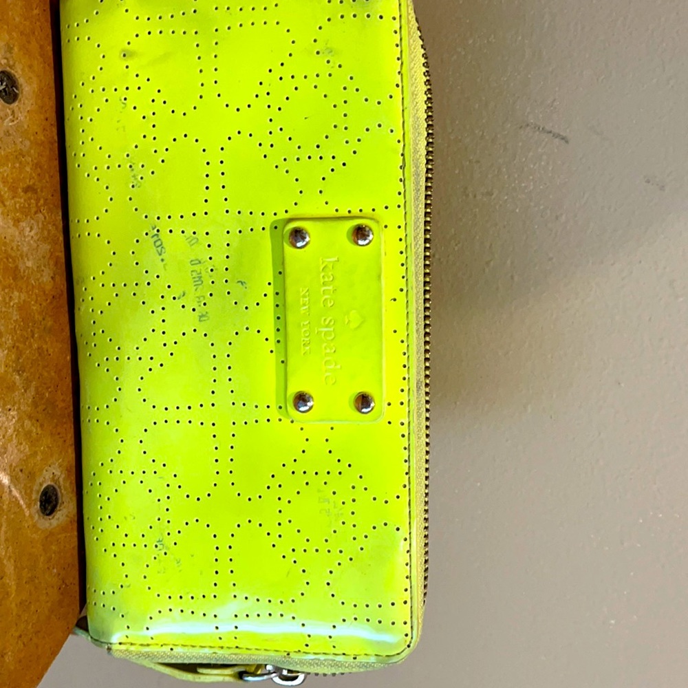 A Beautiful Line green wallet with a few spots.